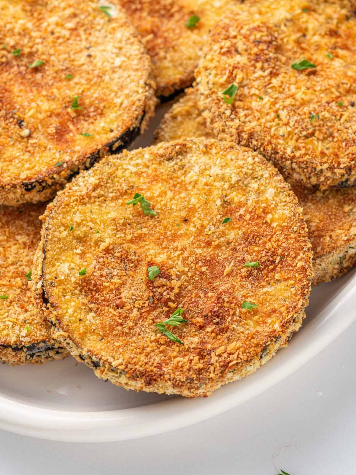 Close up of breaded crispy eggplant on a plate.