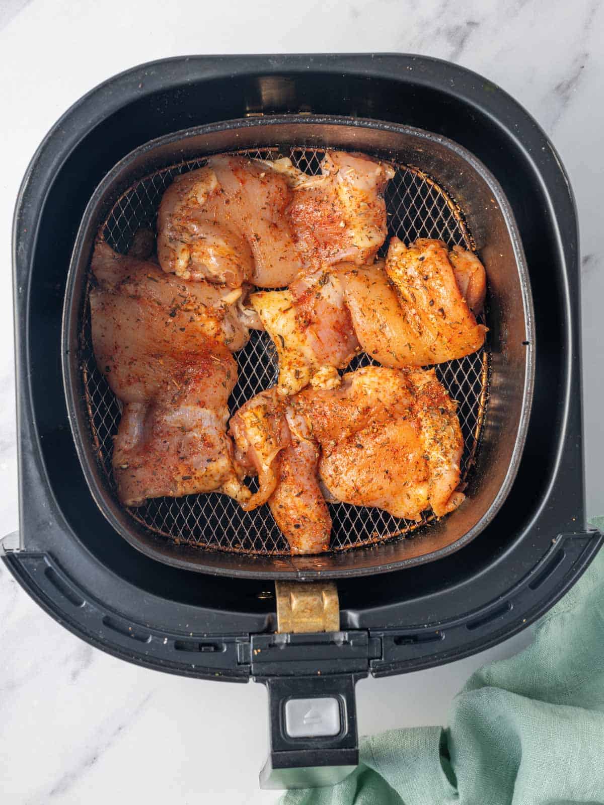 Chicken thighs ready to be cooked in the air fryer.