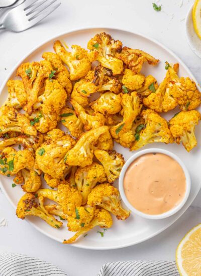 Cauliflower bites on a tray with dip.