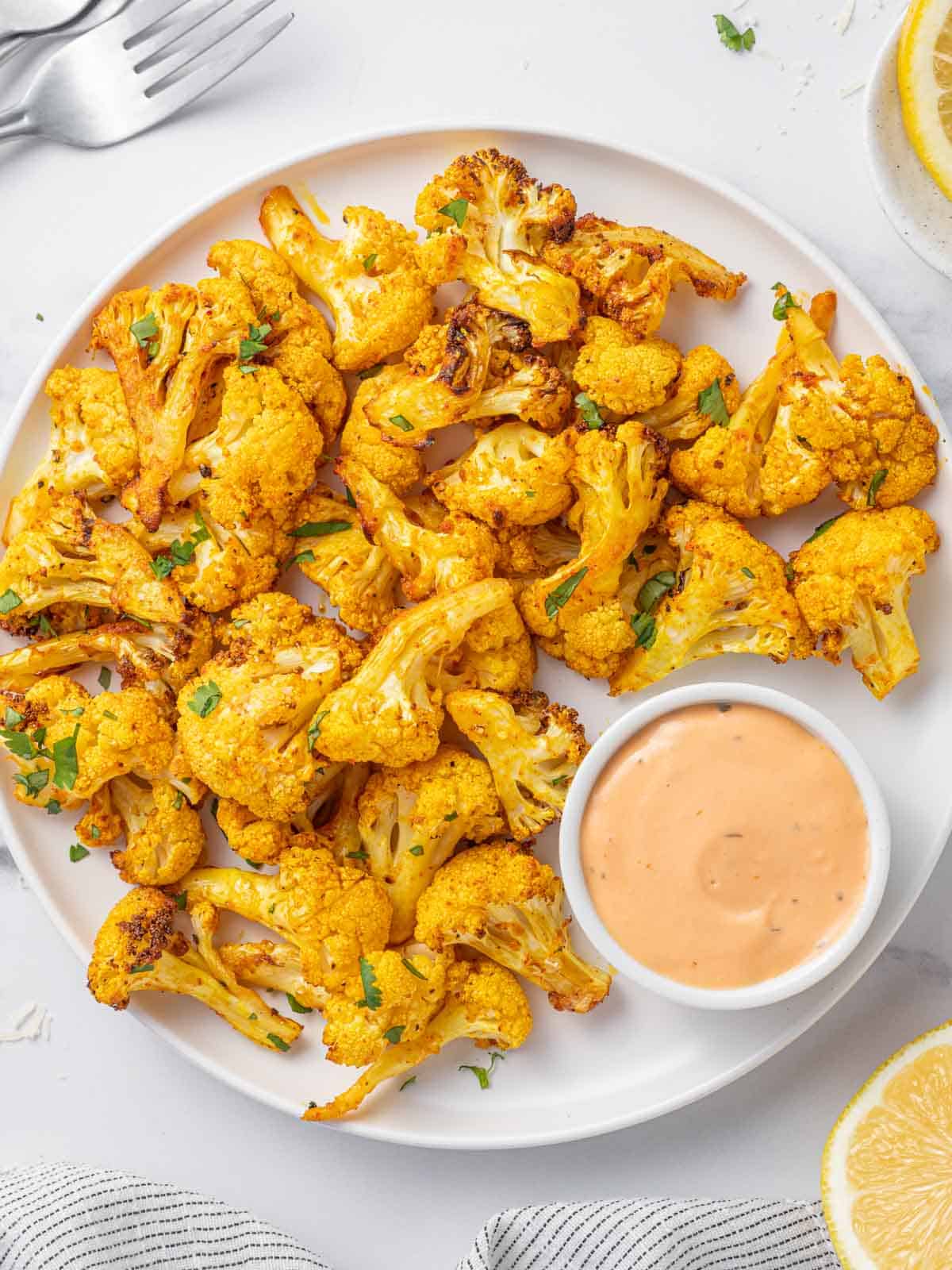 Cauliflower bites on a tray with dip.