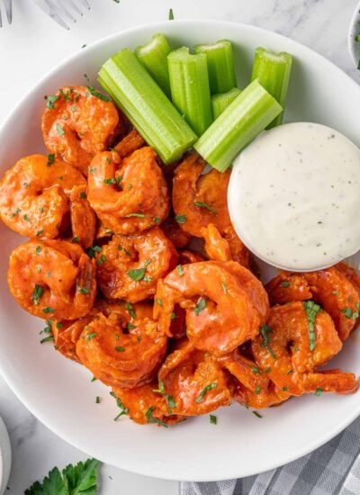 A plate of spicy fried shrimp and creamy dressing.