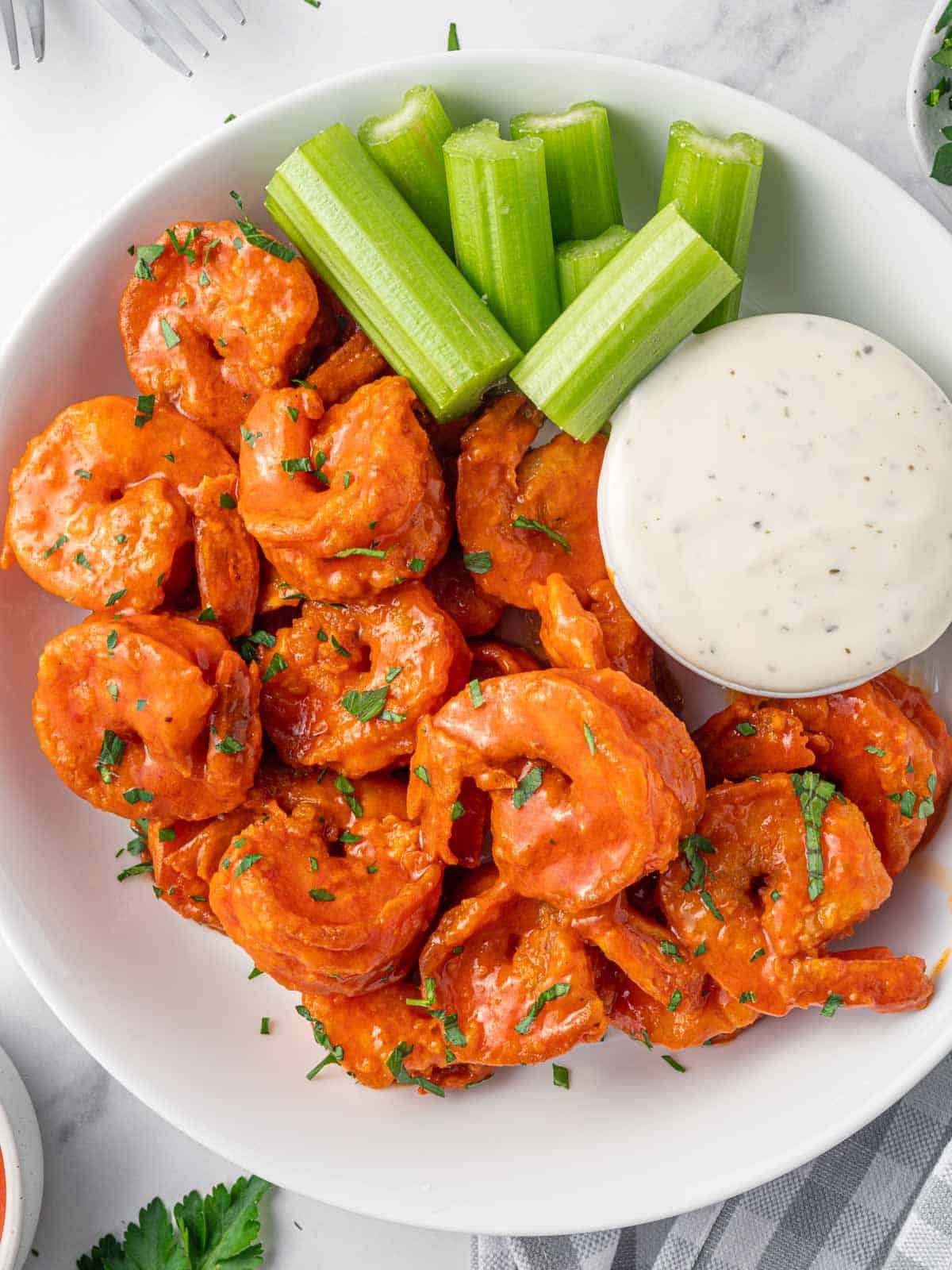 A plate of spicy fried shrimp and creamy dressing.
