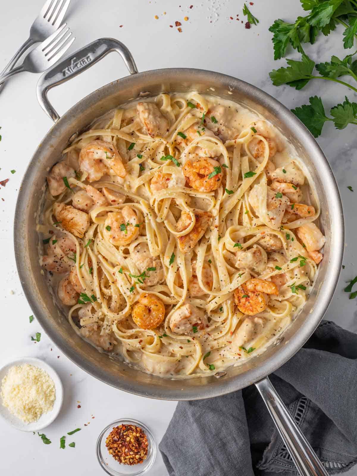 A skillet of creamy chicken and shrimp alfredo.