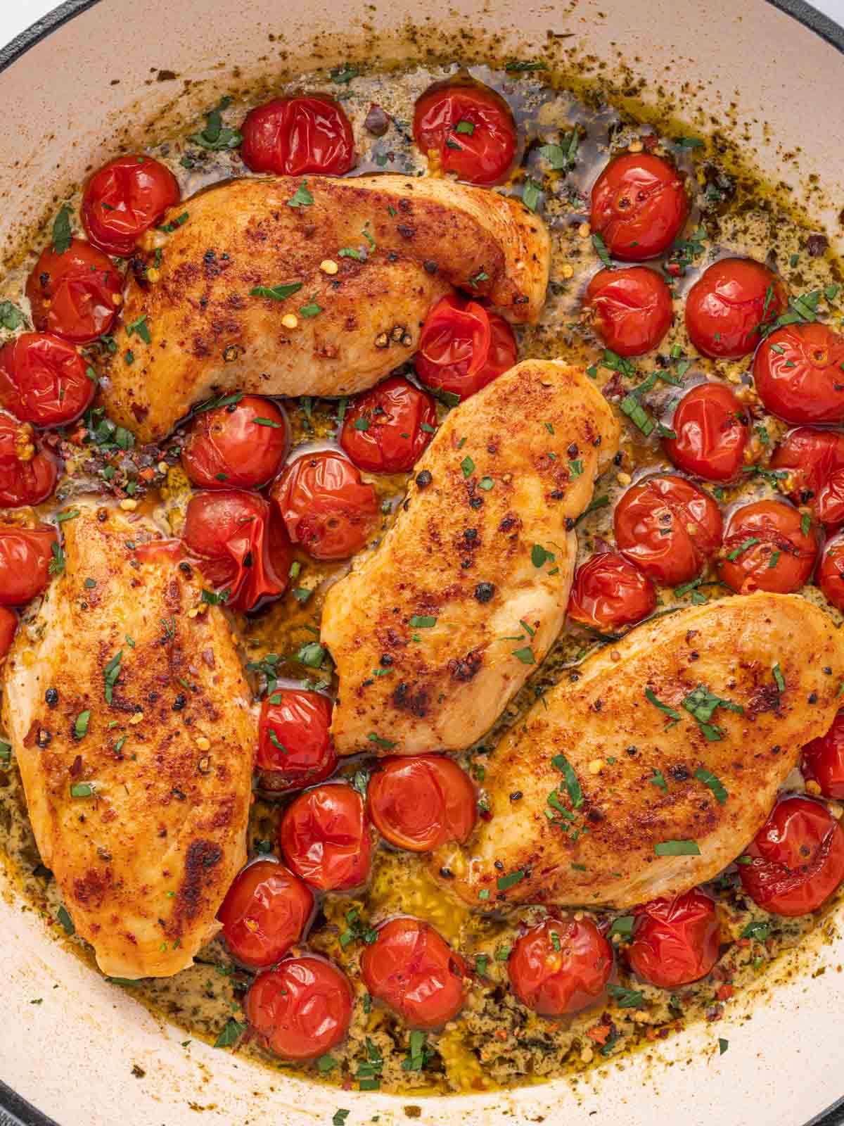 Sauteed chicken with creamy pesto sauce and tomatoes.