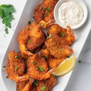 A platter of breaded butterfly shrimp.