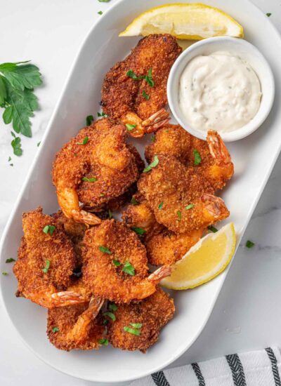 A platter of breaded butterfly shrimp.