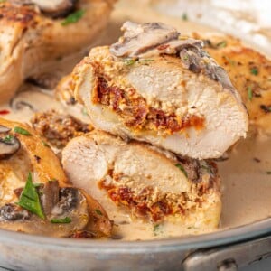 Stuffed chicken marsala cut in half in a skillet.