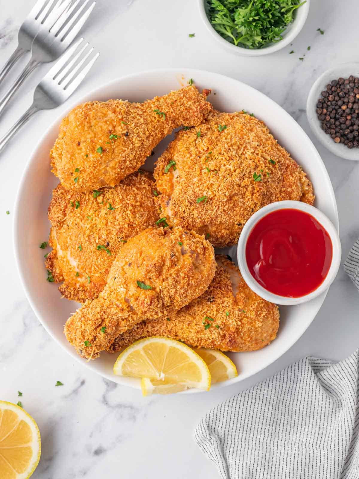 A bowl of crunchy fried chicken with dipping sauce.