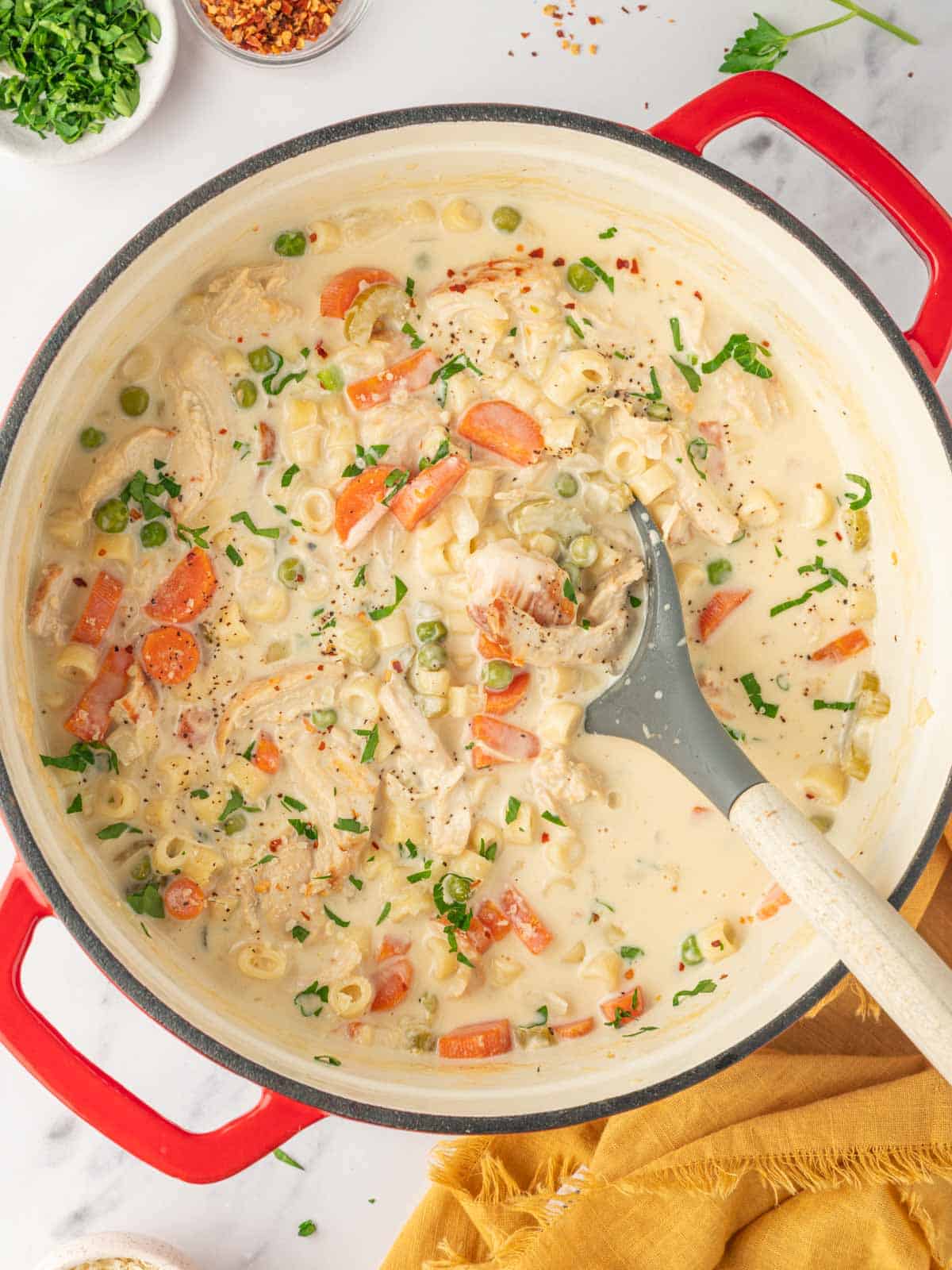 A large pot of creamy vegetable and chicken soup.