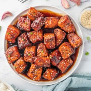 A bowl of honey glazed salmon.