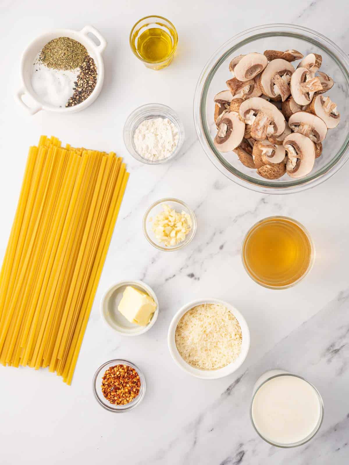 Ingredients needed for creamy mushroom pasta.