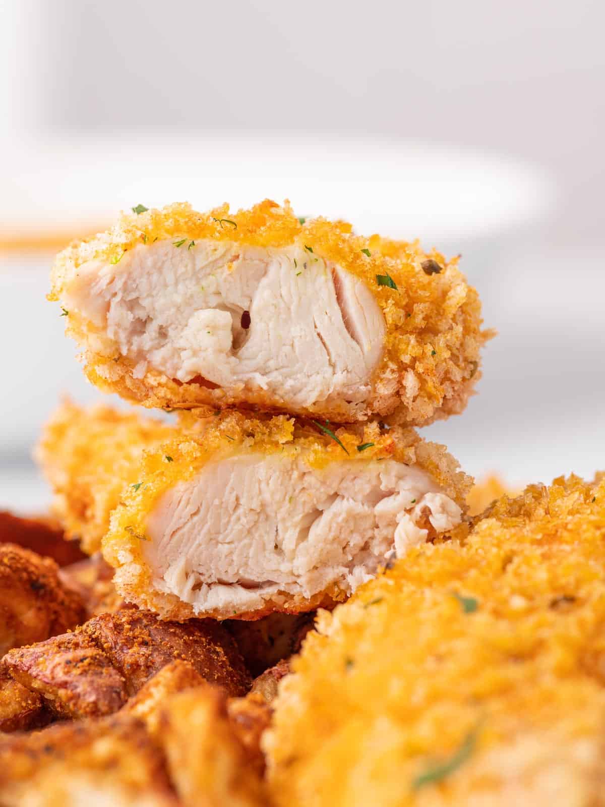 Juicy panko crusted chicken strip sliced in half.