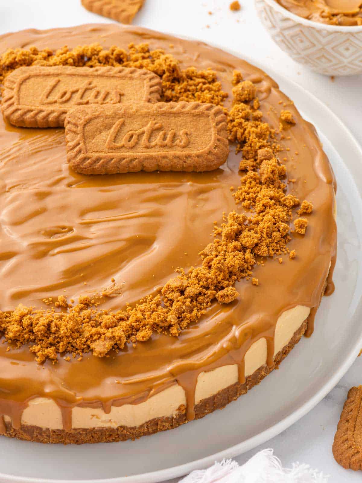 Closeup of a cheesecake topped with biscoff cookie butter.