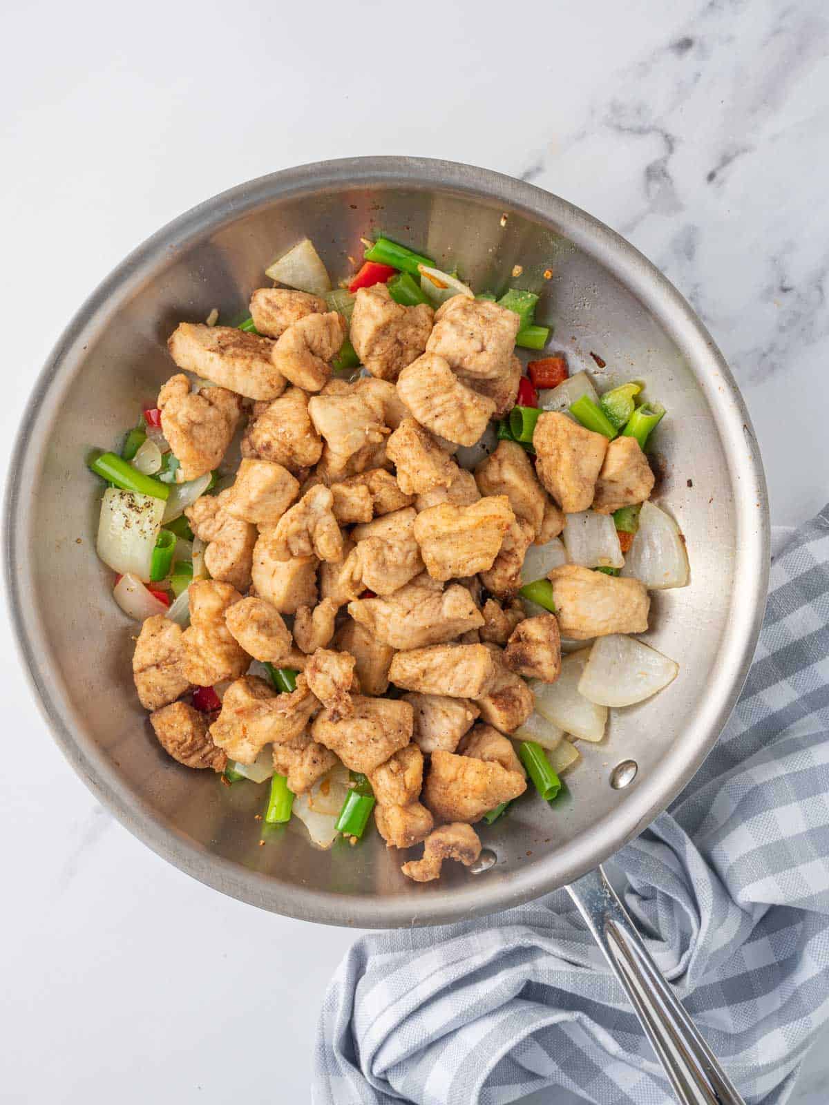 crispy salt and pepper chicken in a wok.