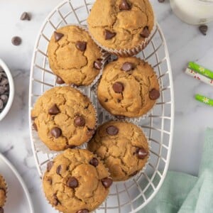A basket of banana muffins with chocolate chips.