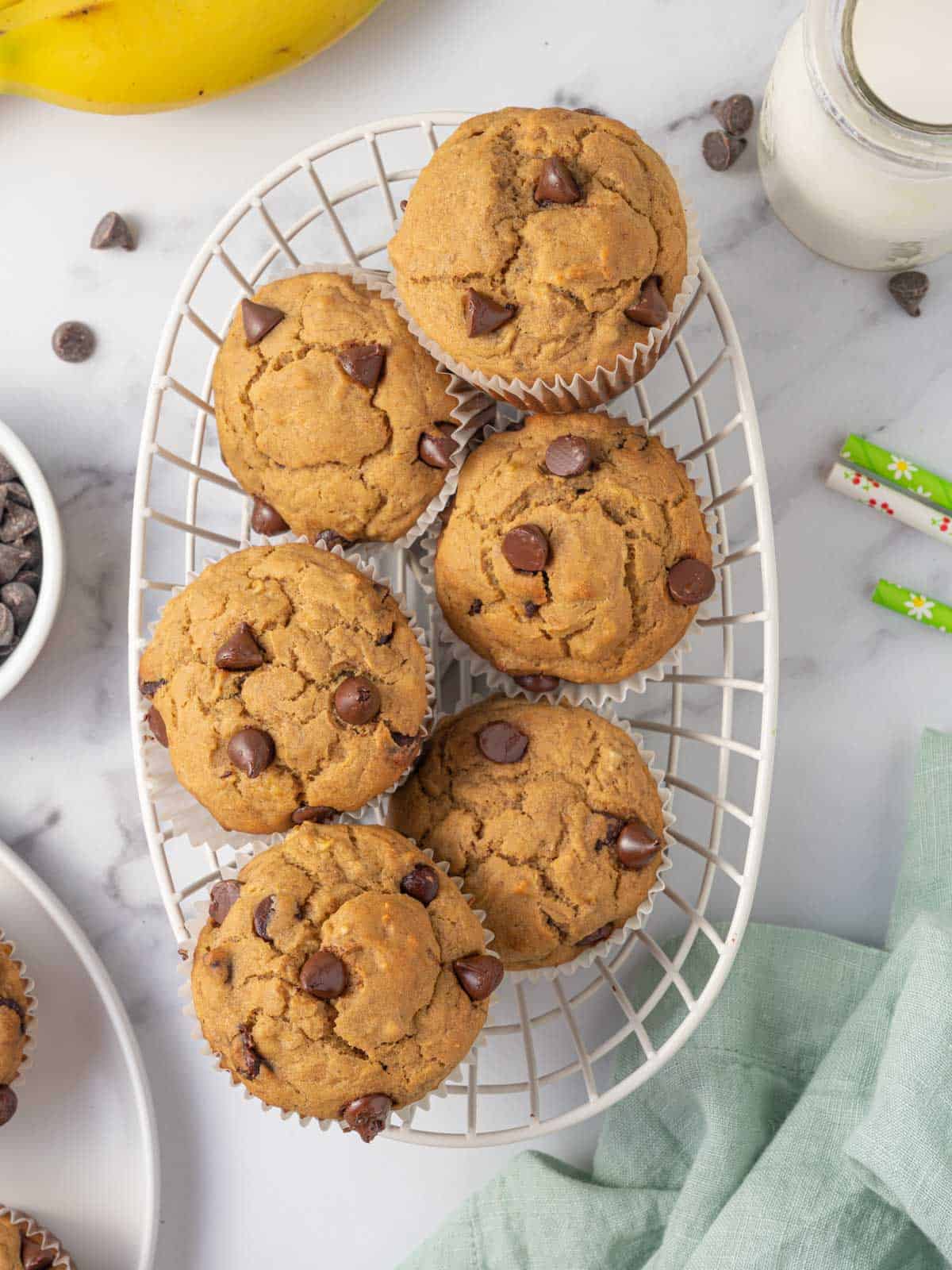 A basket of banana muffins with chocolate chips.