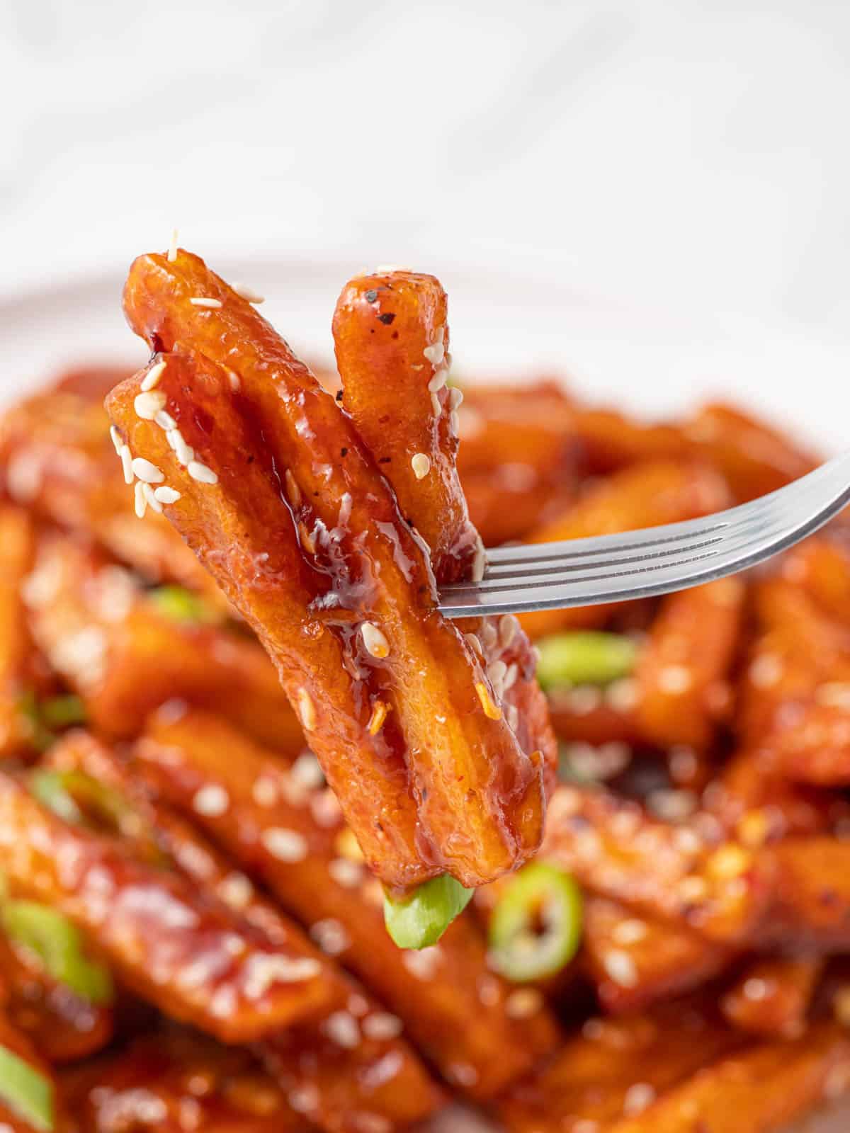 A fork pick of a serving of stick sweet fries.