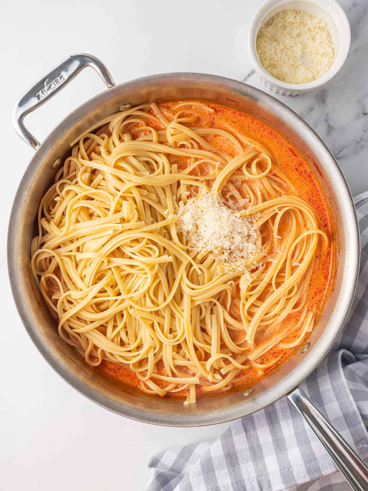 Combining pasta with gochujang sauce.