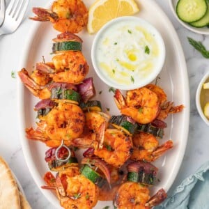 Greek shrimp kabobs with dipping sauce.