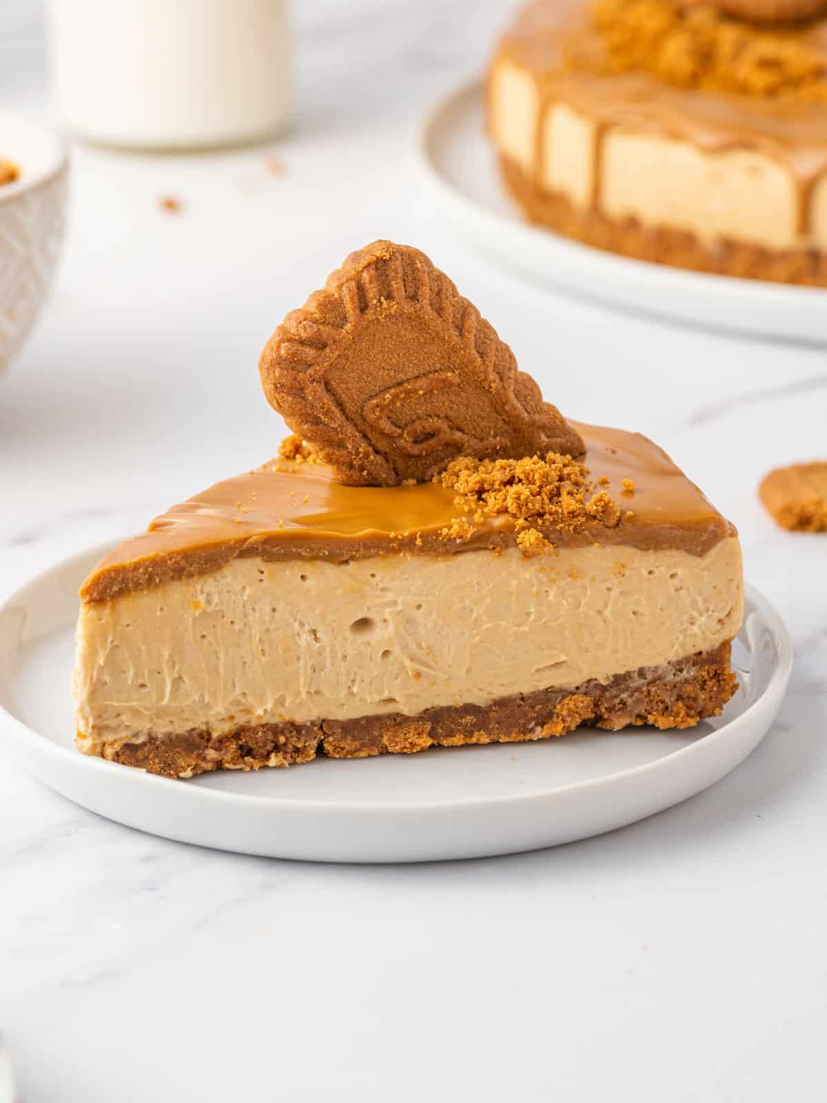 A slice of lotus biscoff no bake cheesecake on a plate.
