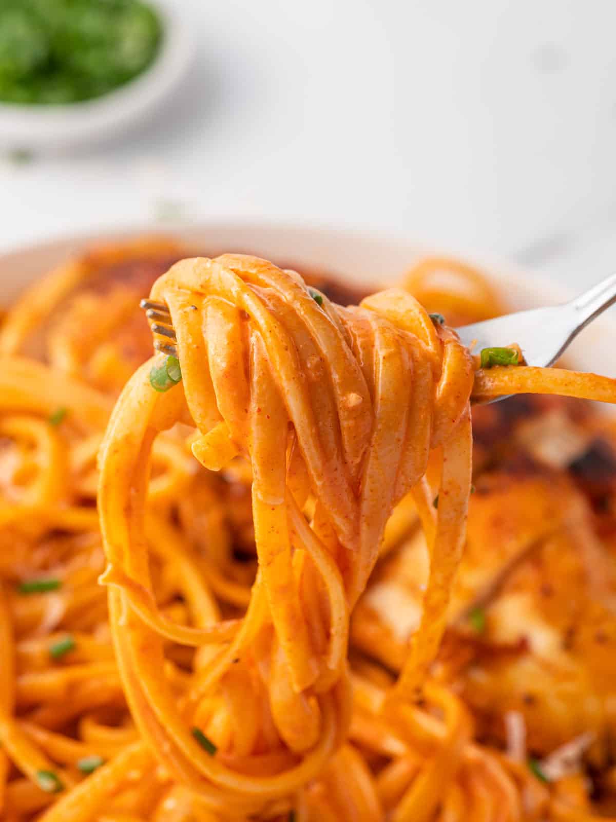 A fork full of linguine with gochujang sauce.