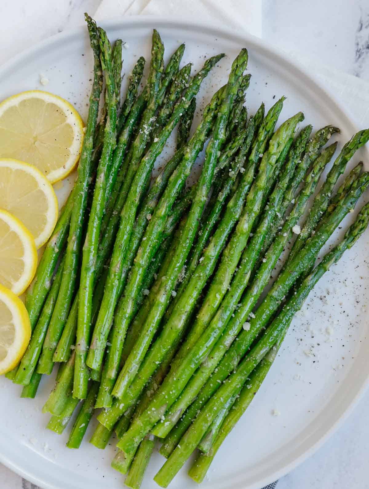 Crispy air fried asparagus on a plate.