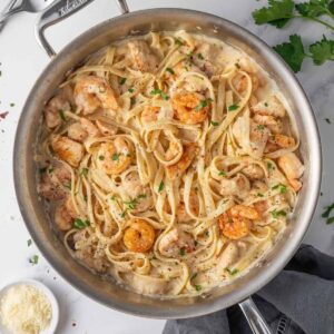 Creamy chicken and shrimp Alfredo with fettuccine, seasoned chicken, shrimp, and fresh parsley.