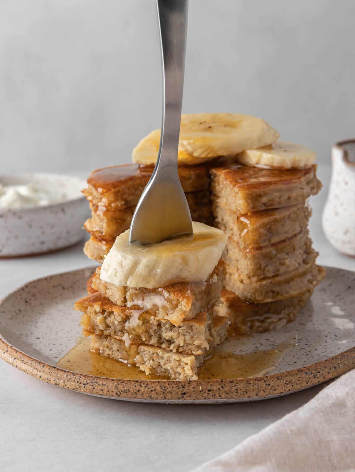 A fork picks up a bite of protein pancakes.