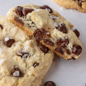 A soft and chewy cookie with a bite taken from it lays on top of another cookie.