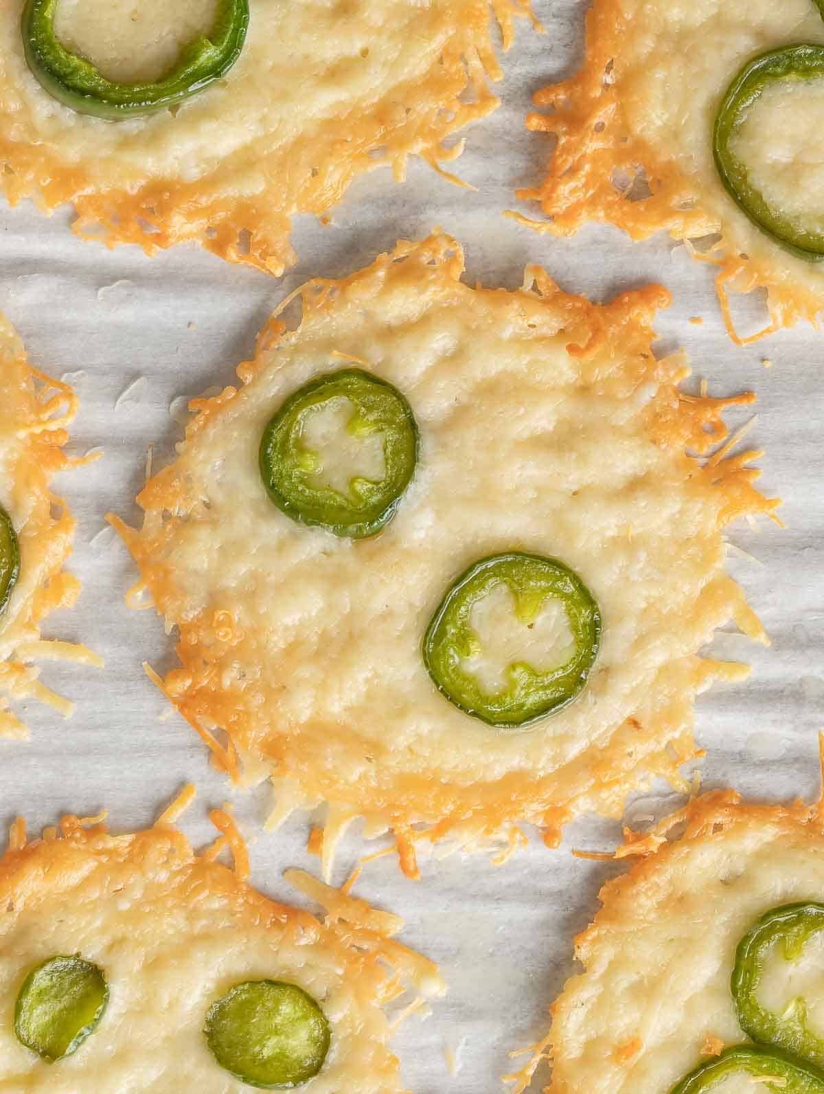 Parmesan chips topped with slices of jalapeno.