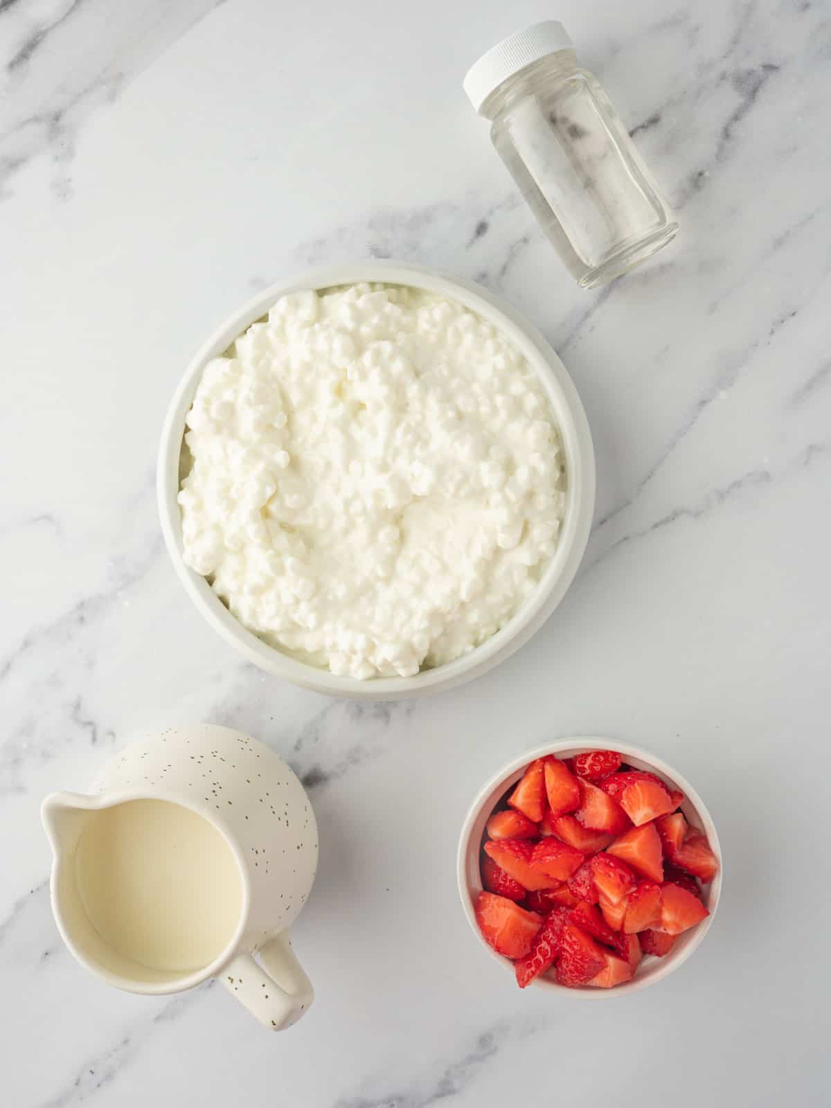 Ingredients needed for strawberry cottage cheese ice cream.