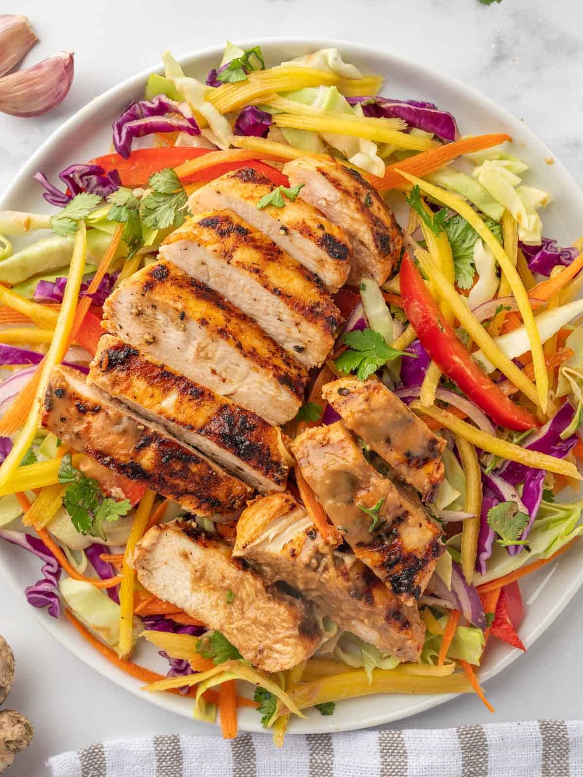 Top view of grilled chicken and mango thai salad.