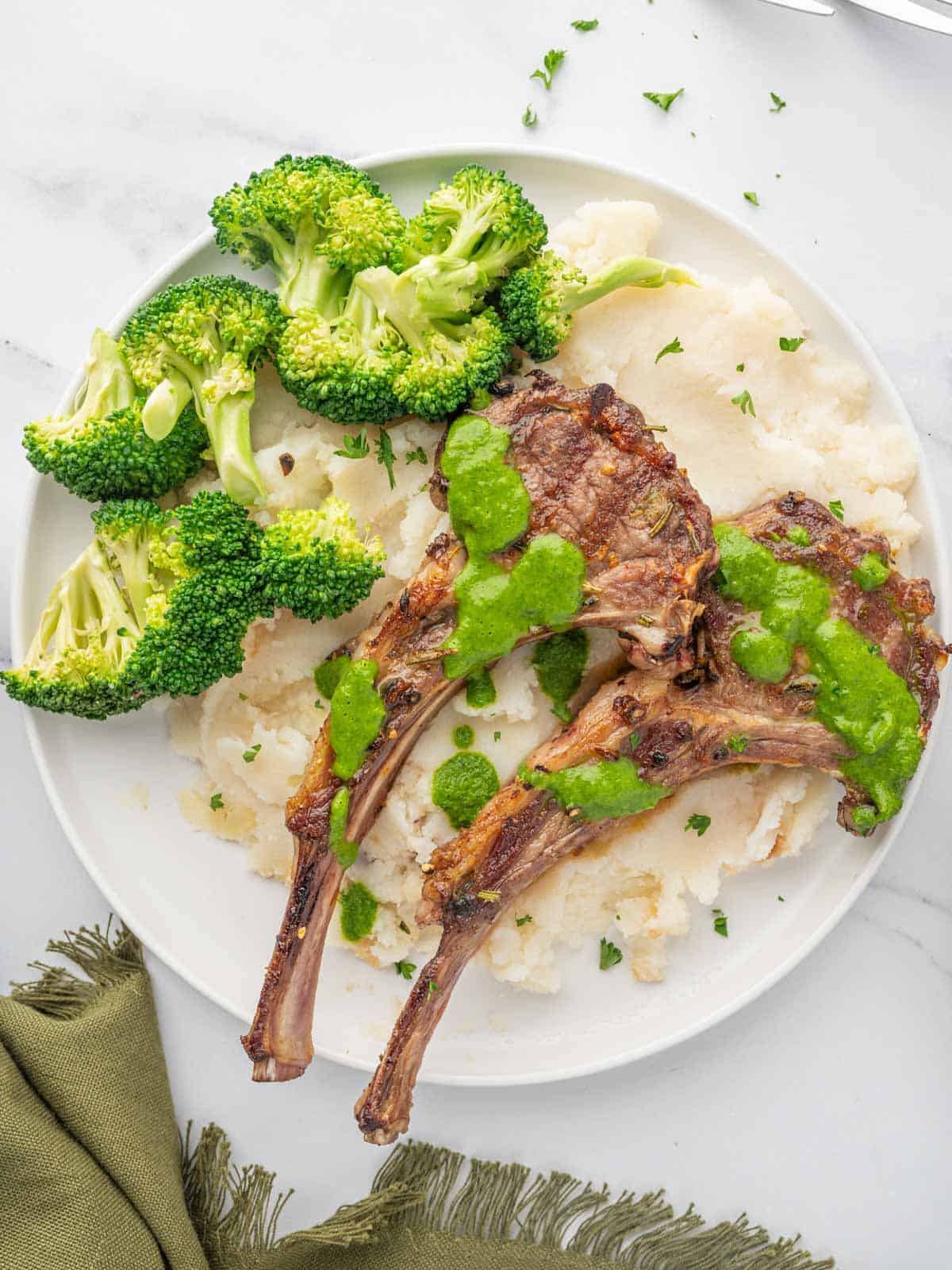 Mediterranean lamb chops with mashed potatoes and broccoli.