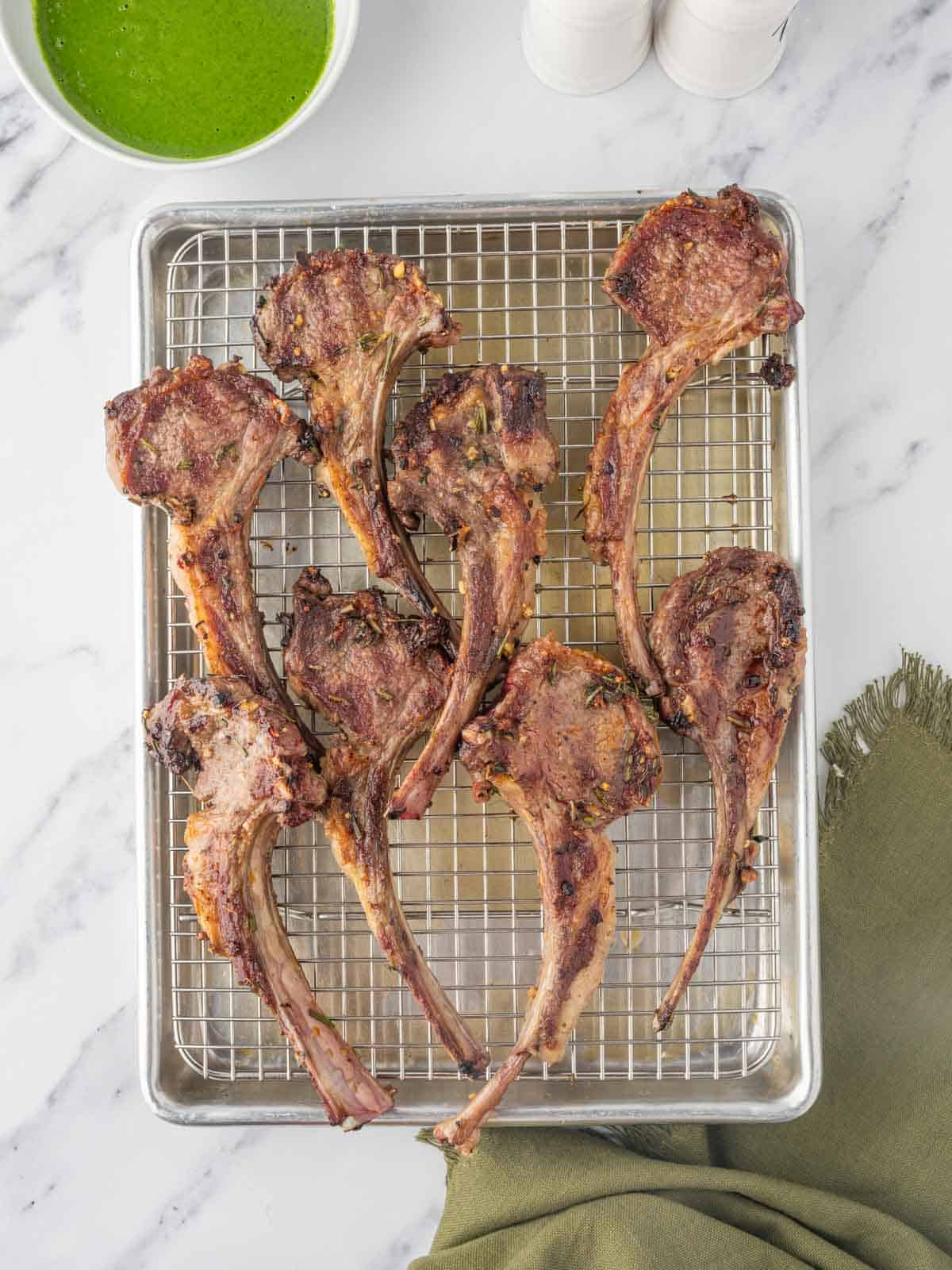 Grilled lamb chops resting on a platter.
