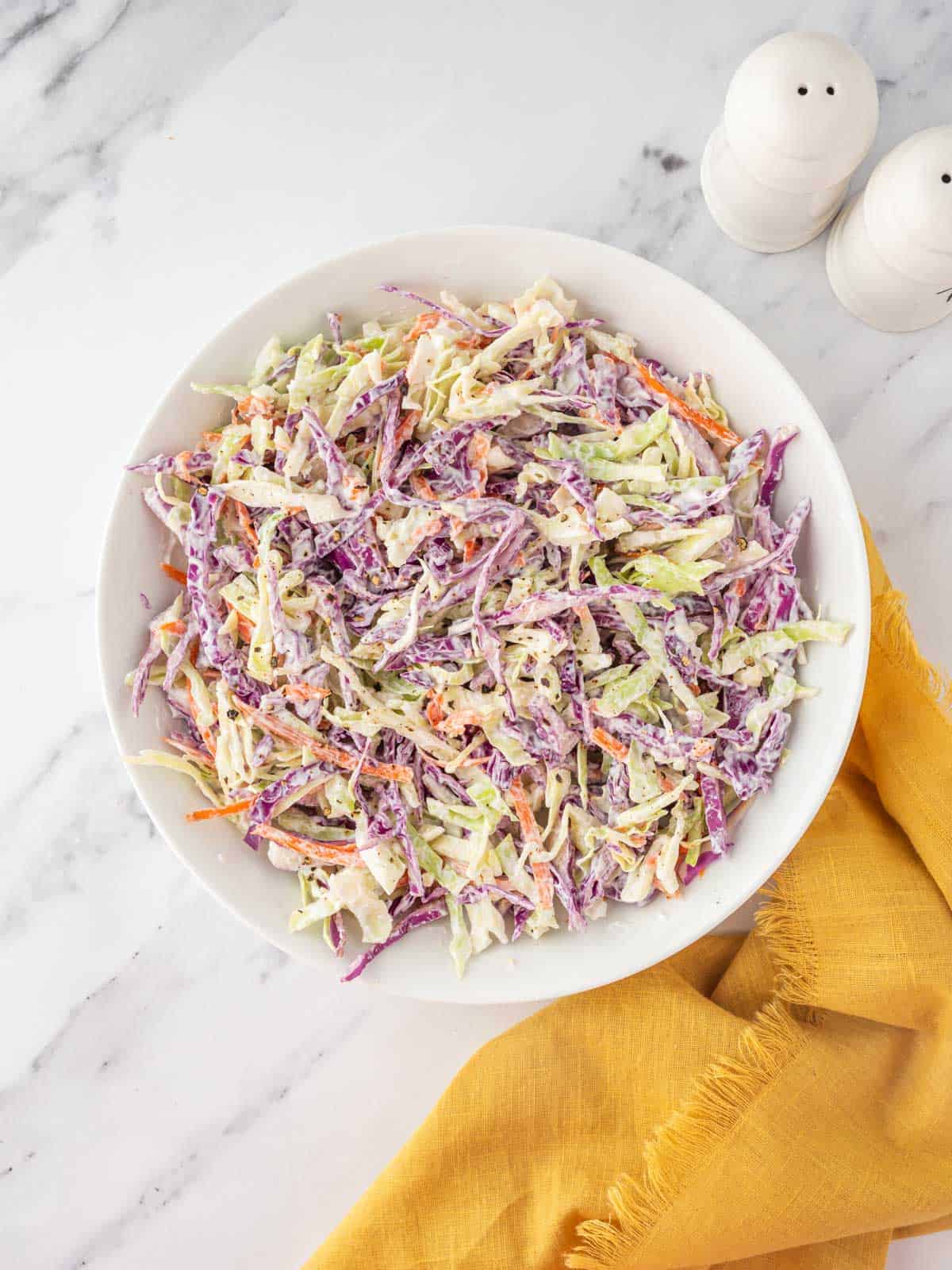 A bowl of homemade coleslaw to serve with bbq chicken.
