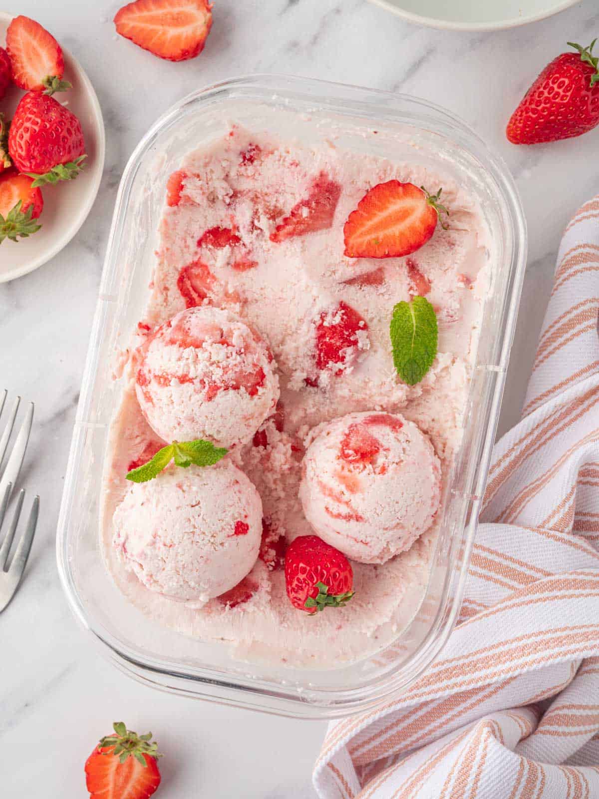 Strawberry ice cream in a container.