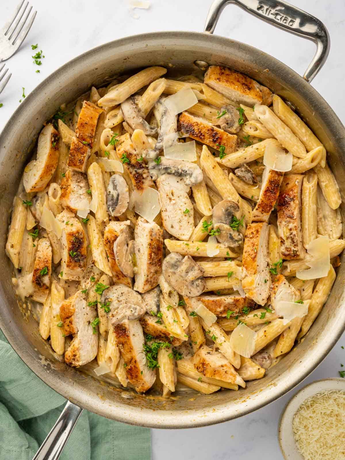 A skillet is filled with Garlic Parmesan Chicken pasta.