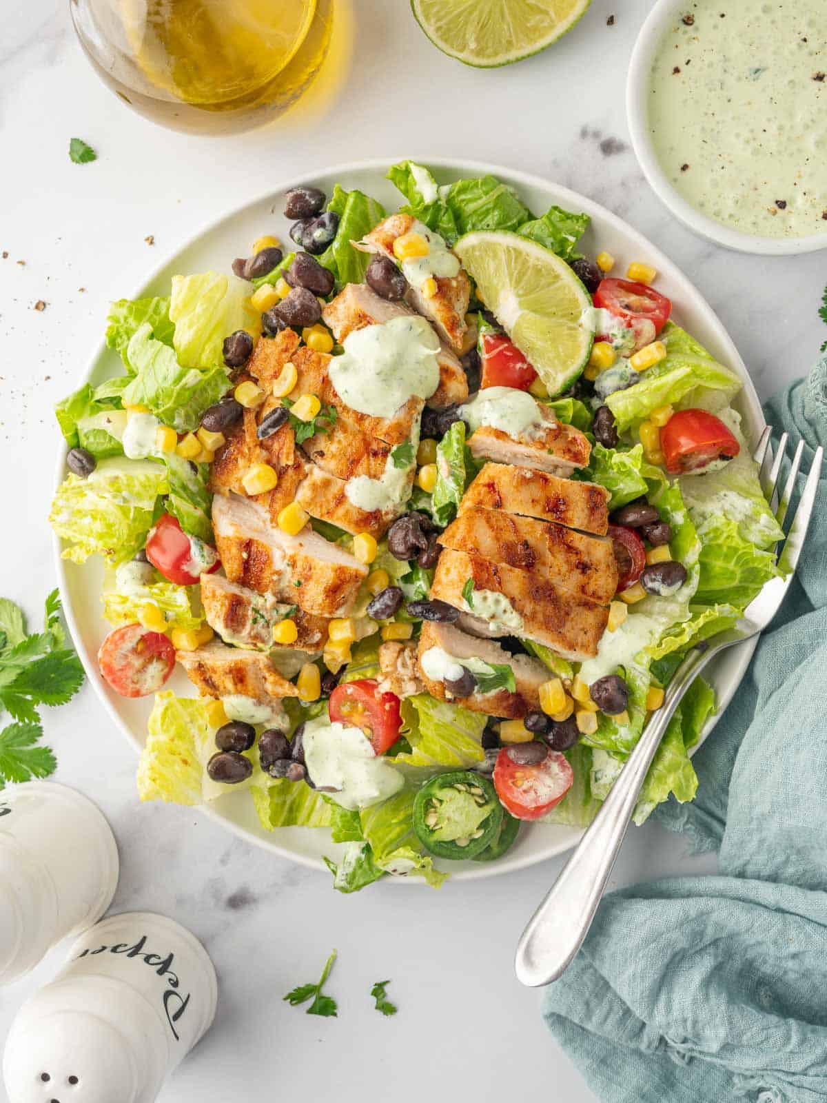 A fork rests on a plate with Santa Fe Grilled chicken salad.