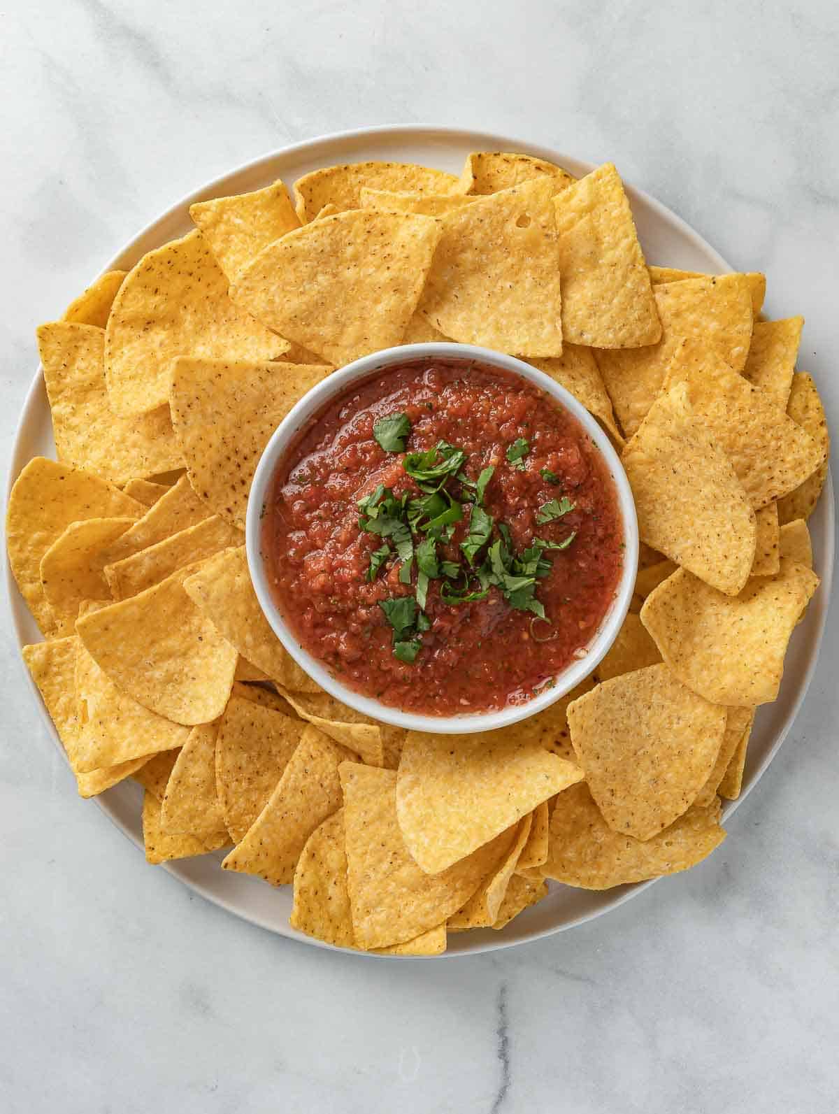 salsa and chips on a plate.