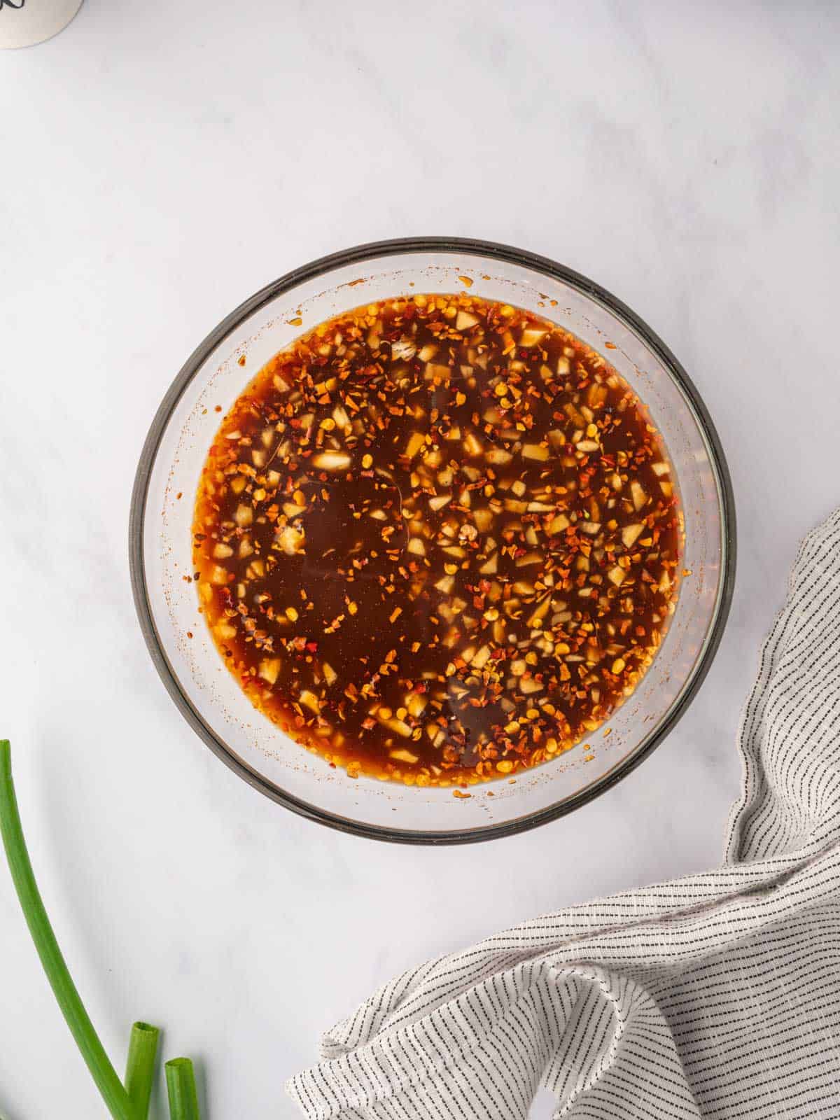 Spicy hunan chicken sauce in a bowl.