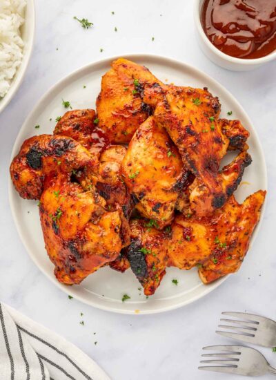 Barbecue chicken thighs on a plate.