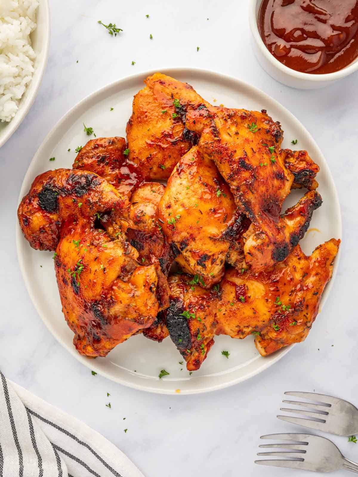 Barbecue chicken thighs on a plate.