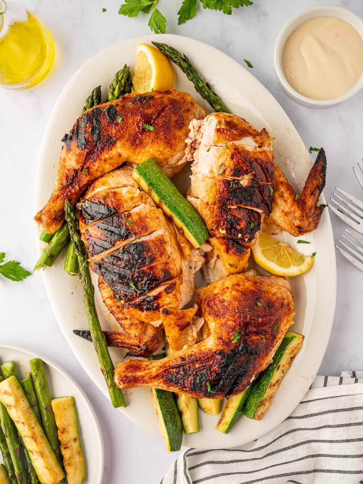 Charcoal chicken recipe is cut into pieces on a platter.