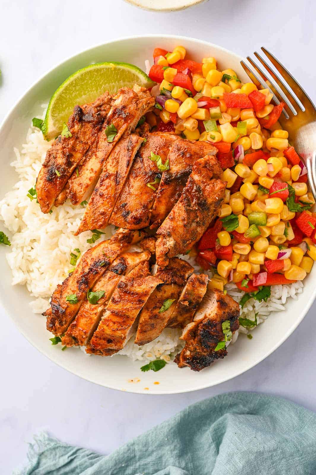 Chicken asado with rice and Mexican corn.