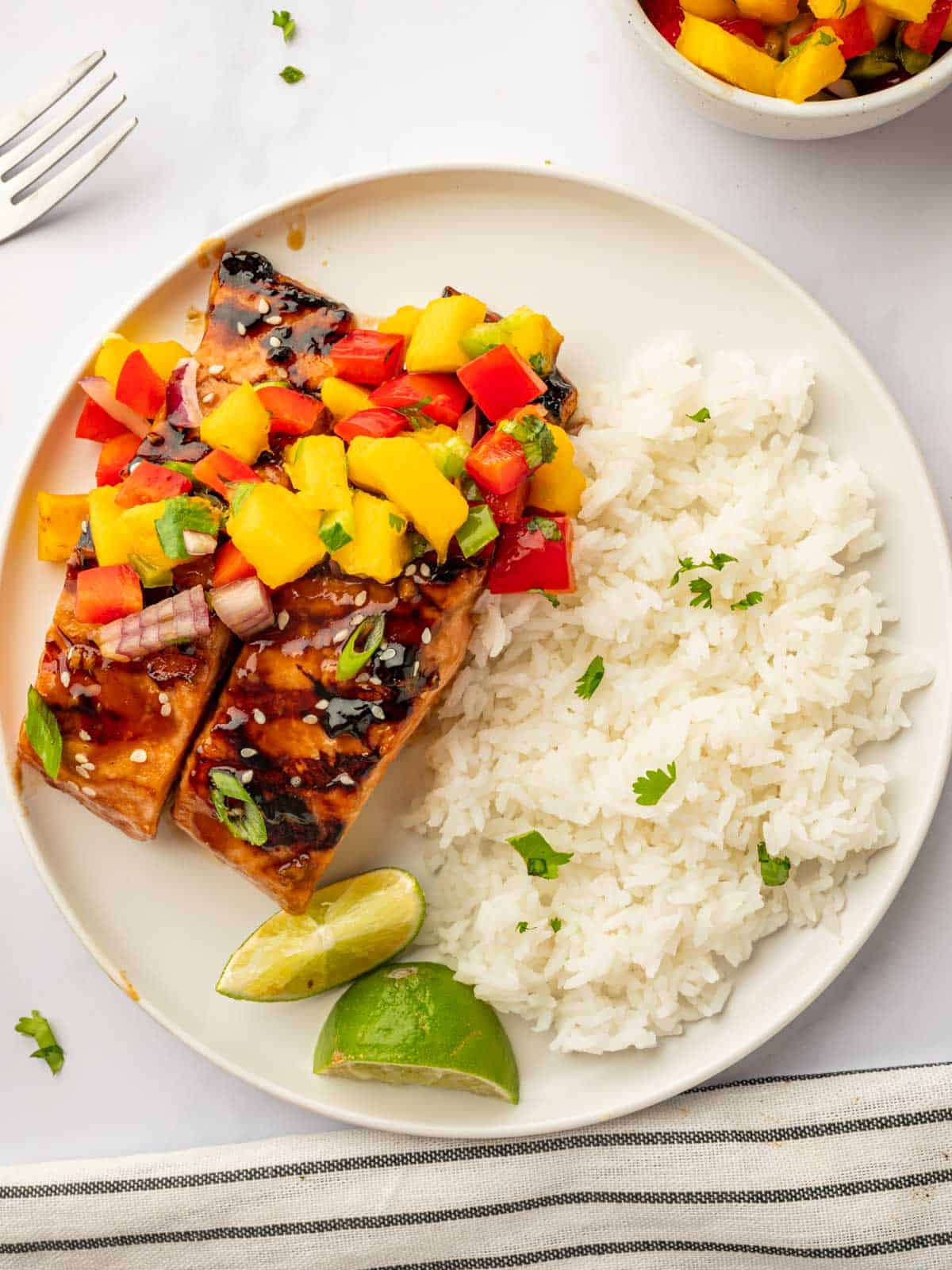 Serve marinated grilled salmon recipe on a plate with rice.