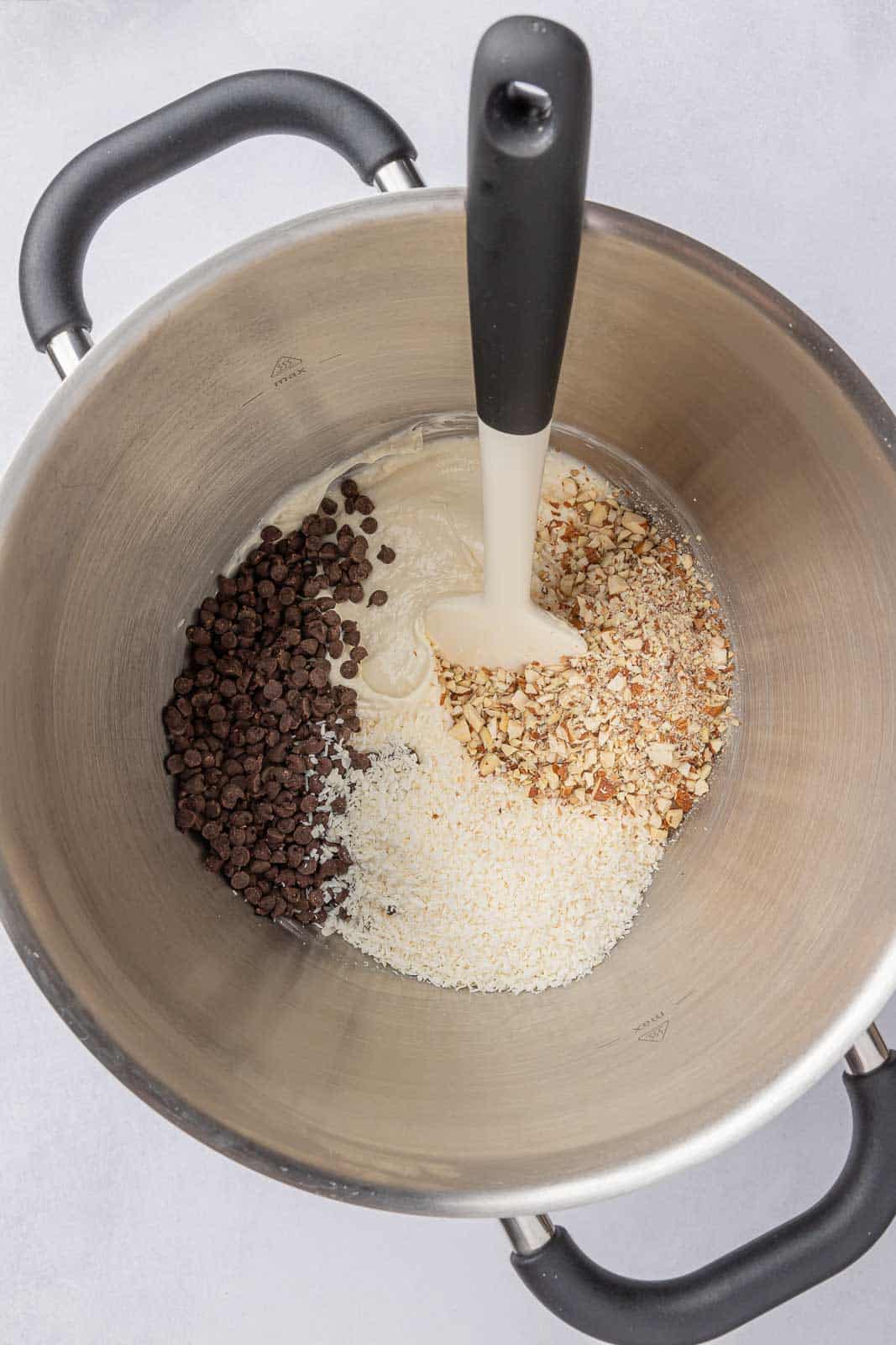 Filling of almond joy cheesecake filling in a pan.