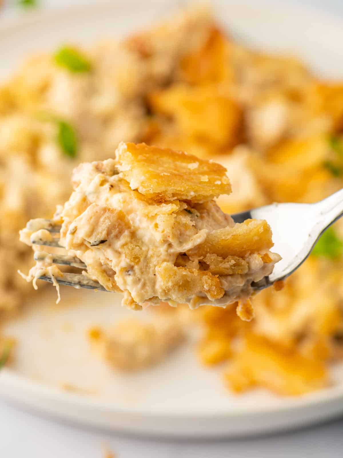 A fork serves of a bite of the best chicken casserole ever.