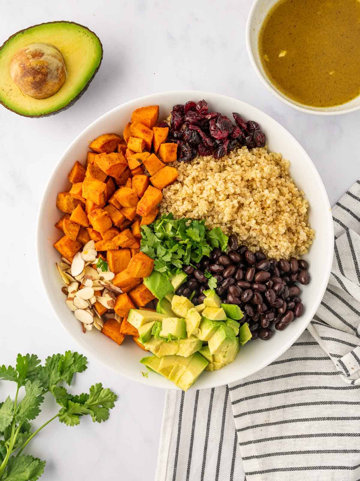 Ingredients for quinoa salad piled in a bowl.