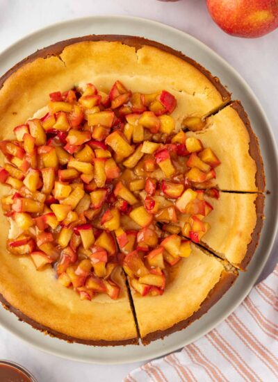 Apple cheesecake cut into slices.