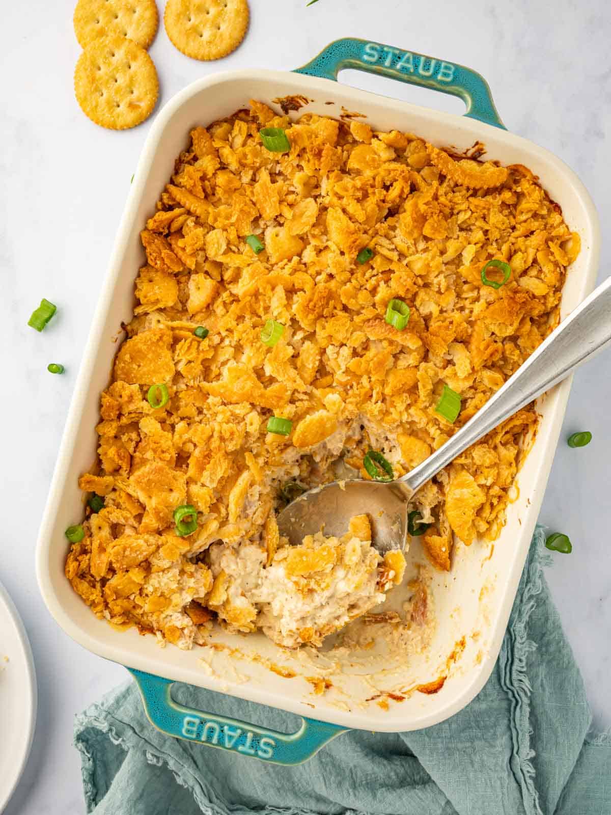 A spoon rests in a chicken casserole dish.